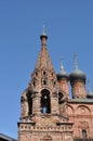 Close up of the top of a brick bell tower with bells