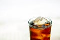 Close up top of cola glass with white background. sparkling soda drinking.