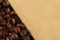 Close up, top down of texture of freshly roasted coffee beans and coffee cone filter from unbleached, recycled paper. Macro food