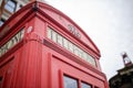 Close up of the top of a London telephone booth with a bright sky over it Royalty Free Stock Photo
