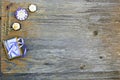 Close up, top shot of assorted organic, handmade, botanical flower shape soaps with lavender, rosemary, purple ribbon on rustic