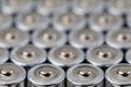 Close up top view on blurred rows of AA batteries energy abstract background of batteries.
