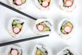 Top view california rolls sushi on plate with chop sticks