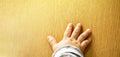 Close up top view of child`s hand on wooden background