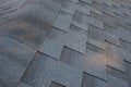 Close up top view on corner roof made is asphalt roofing shingles.