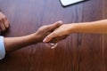 Close-up top view handshake of unrecognizable business man and woman after signing contract of collaboration. Royalty Free Stock Photo