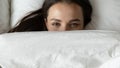 Happy girl hide under blanket relaxing in bed Royalty Free Stock Photo