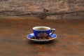 Close-up and top view of hot black coffee in blue coffee cup and roasted Thai coffee beans on wooden background Royalty Free Stock Photo