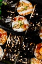 Close-up top view on kappa maki sushi rolls drizzled with soy sauce and sesame seeds Royalty Free Stock Photo