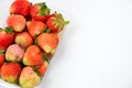 Close up top-view near ripe red strawberry in plastic transparency pack, isolated on white background, copy space write Royalty Free Stock Photo