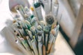 Close up top view pack of watercolor painting hair brushes in basket, copy space
