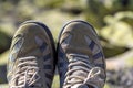 Close-up top view of pair of old worn comfortable men`s classic white sneakers with gray inserts. Modern sport wear for men and w