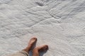 Close-up top view of Pamukkale travertine details with human foot, Denizli, Turkey Royalty Free Stock Photo