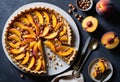 A close-up top view of a peach fruit tart with sliced peaches and hazelnuts on top Royalty Free Stock Photo