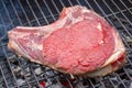 Close-up of a raw beef rib on a barbecue grill Royalty Free Stock Photo