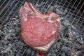 Close-up of a raw beef rib on a barbecue grill Royalty Free Stock Photo