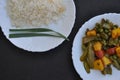 Close-up top view of rice and matar paneer mix veg on white plate over black background