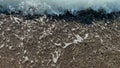 Close Up top view sea beach sea waves breaking on sandy coastline. Beautiful Turkish nature. Close-up shot of calming Royalty Free Stock Photo