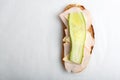 close up top view shot of a single white bread turkey ham and cheese sandwiches with a slice of cucumber on top on a Royalty Free Stock Photo