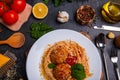 Close-up, top view, spaghetti with grated cheese and meatballs on a plate, wooden table. Royalty Free Stock Photo