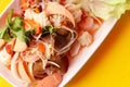 Close up top view spicy salad of vermicelli and seafood in white plate on yellow background, Thai food Yum Woon Sen Royalty Free Stock Photo