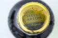 Close up top view of a Stella Artois beer bottle on a white background