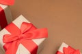 Close-up brown paper gift box red bow ribbon brown background. concept for happy love gift Royalty Free Stock Photo