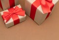 Close-up brown paper gift box red bow ribbon brown background. concept for happy love gift Royalty Free Stock Photo