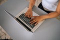 Close-up top view of unrecognizable African-American business woman using typing on laptop notebook keyboard sitting at Royalty Free Stock Photo