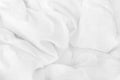 Close up top view of white bedding sheet and wrinkle messy blanket in bedroom after wake up in the morning