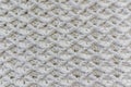 Close-up of a top view of a white cotton blanket with an original embossed crochet stitch pattern Royalty Free Stock Photo