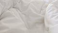 Close up top view of white pillow on bed and with wrinkle messy blanket in bedroom Royalty Free Stock Photo