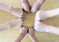 Close up top view of young people putting their hands together. Friends with stack of hands showing unity and teamwork. Royalty Free Stock Photo