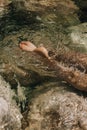 Close-up top view of a young woman's bare feet in a water Royalty Free Stock Photo