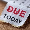Close-up of torn paper with 'DUE TODAY' on cork board. Royalty Free Stock Photo