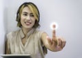 Close-up touching point on virtual screen touched by Asian woman finger. Royalty Free Stock Photo