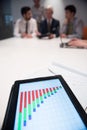Close up of touchpad with analytics documents at business meetin Royalty Free Stock Photo