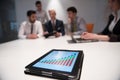 close up of touchpad with analytics documents at business meeting Royalty Free Stock Photo