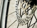 Close up touring bicycle disc brake at front wheel in selective focus.