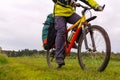 Tourist bike riding through the field, closeup