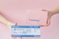 Close up tourist female horizontal hold in hand tickets for plane with orange passport, boarding pass, isolated on yellow