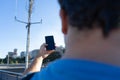 close-up Tourist With No Cellphone data Or Network. Man holding mobile phone and searching for signal internet connection. Royalty Free Stock Photo