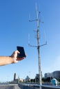 close-up Tourist With No Cellphone data Or Network. Man holding mobile phone and searching for signal internet connection. Royalty Free Stock Photo