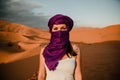 Tourist woman in purple turban looking at camera