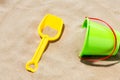 Close up of toy bucket and shovel on beach sand Royalty Free Stock Photo