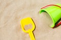 Close up of toy bucket and shovel on beach sand Royalty Free Stock Photo