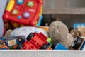 Close up of toys, with many different objects including soft toys, play cars and toddler toys