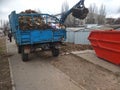 Close-up of a tractor bucket removes autumn leaves on the street in the city of Novaya Kakhovka, Kherson region, Ukraine 21.21.202