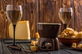 Close up. Traditional alpine cheese fondue. Burning candle heats fondue pot. Winter seasonal meal. Copy space Royalty Free Stock Photo