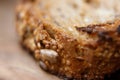 Close-up on traditional bread with cereals and seeds. The texture of the bread with blurred background. Royalty Free Stock Photo
